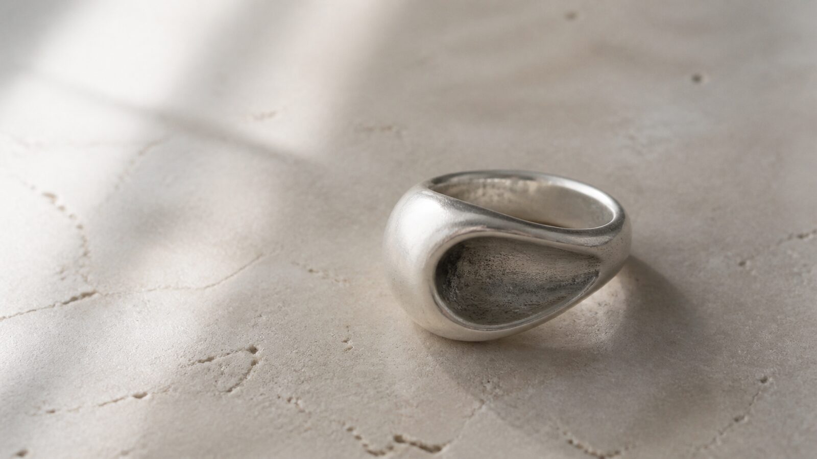 Matte silver ring with an open void